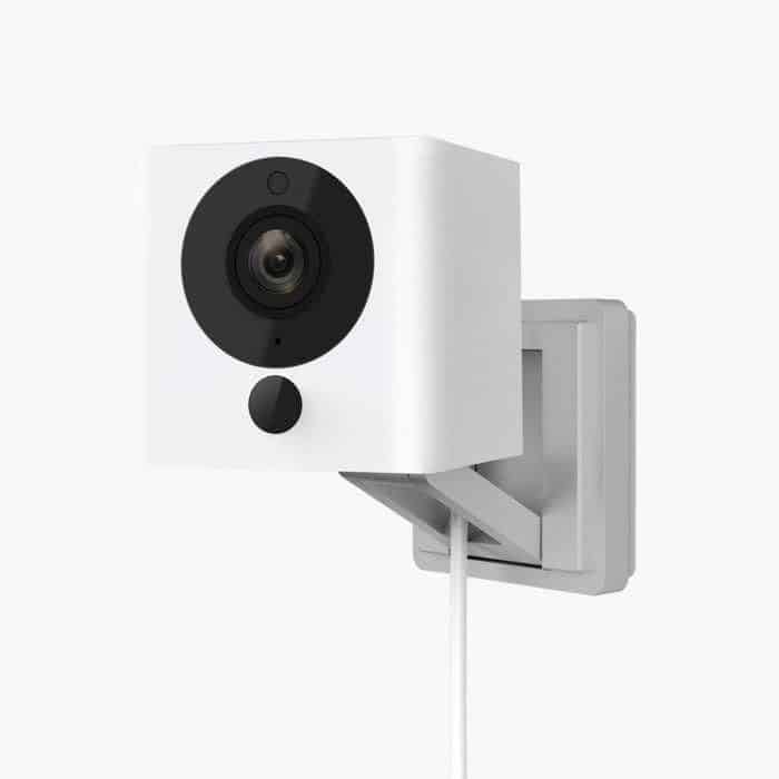 A white Wyze Cam v2 mounted to a wall.