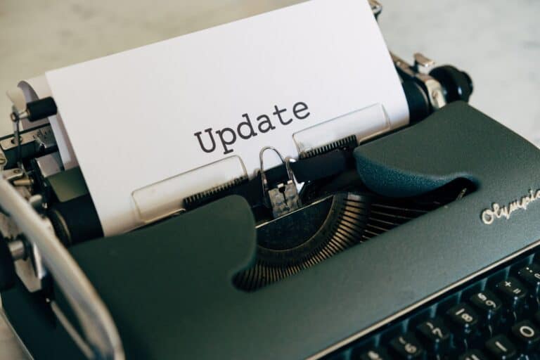 A close-up of a classic black typewriter with a sheet of paper inserted that reads 'Update' in typewritten letters.