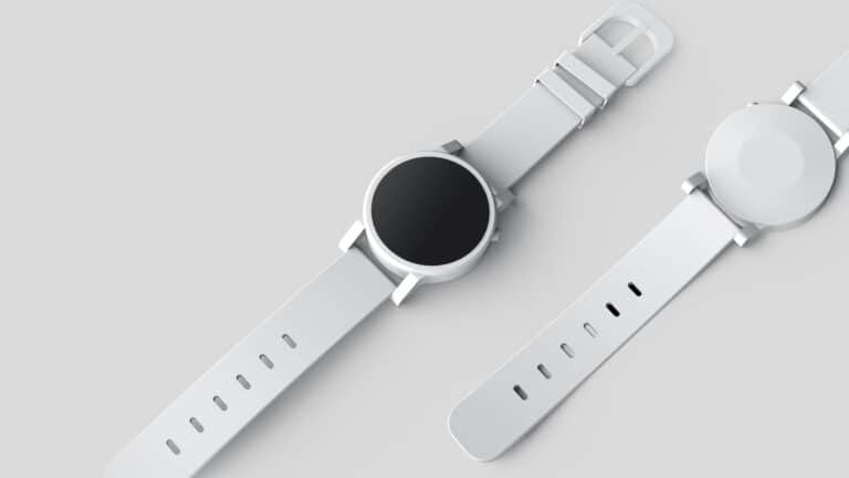 A minimalist design of a smartwatch with a white band and a circular face displaying a black screen, set against a light gray background. The watch has a sleek, modern appearance with no visible buttons or markings on the face.