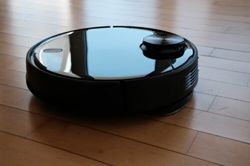 The ILIFE A11 robot vacuum in black on a wooden floor