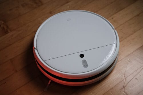 A white Xiaomi Mi Robot Vacuum Mop 1C, pictured from above, on a hard wood floor.