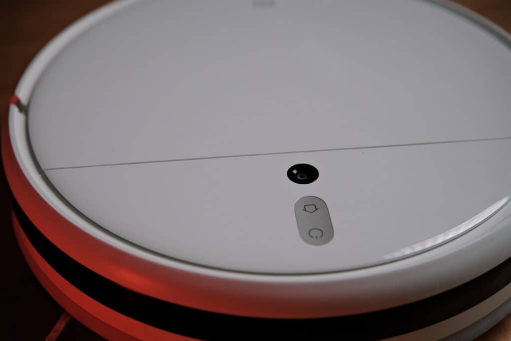 The top side of the Xiaomi Mi Robot Vacuum Mop 1C, showing the round camera, which is placed behind the power and home buttons.