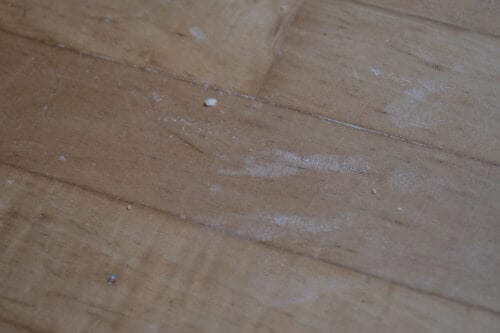 Leftover flour and rice on a hard wood floor after being cleaned by the Xiaomi Mi Robot Vacuum Mop 1C