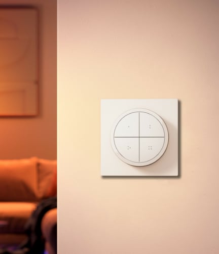 The Swiss version of the Philips Hue Tap dial switch, which features four buttons, a dial, and a square backplate.
